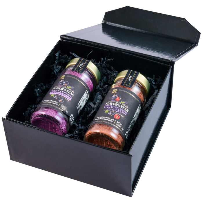 A black gift box displays two McCormick 2026 Flavor of the Year products, including a jar of the Mccormick Culinary Sweet &amp; Smoky Naturally Flavored Black Currant Seasoning, 28.0 Oz, and a jar of Black Currant Finishing Sugar.