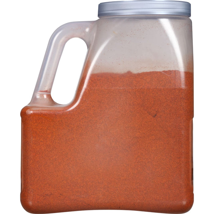 A plastic container filled with red chili powder.