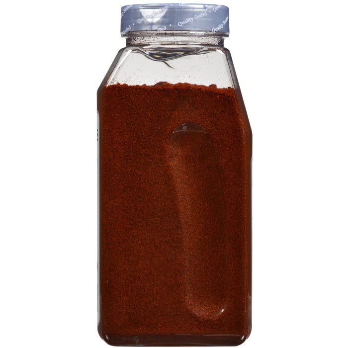 A clear plastic jar with a red powder inside and a blue lid that says Quality Sealed on it.