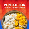 A bowl of rice pudding with mango chunks and toasted coconut flakes perfect for parfaits and puddings.