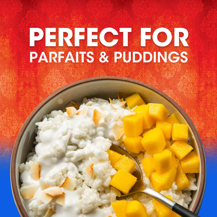 A bowl of rice pudding with mango chunks and toasted coconut flakes perfect for parfaits and puddings.