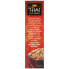 The side of a red box of Thai Kitchen, 9 Oz, describes the authentic Thai-style frozen meal and shows a serving suggestion of the rice and chicken dish in a black bowl.