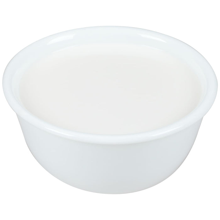 A white bowl filled with a white liquid.