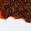 A close-up of chili flakes in oil.