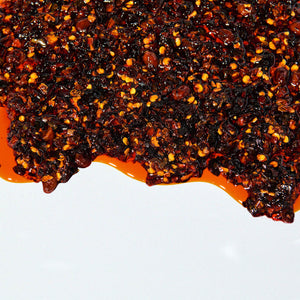 A close-up of chili flakes in oil.