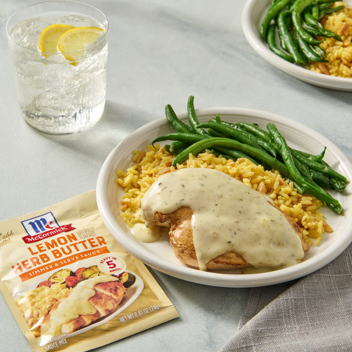 McCormick Lemon Herb Butter sauce mix with a plate of chicken, rice, and green beans.