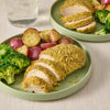 A plate of breaded chicken with potatoes and broccoli.