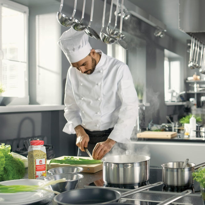 A chef in a white uniform is preparing a meal in a kitchen with Lawry's Lemon Pepper Seasoning.