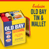 A yellow tin of Old Bay Seasoning with a wooden mallet and a red can opener.