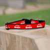 A Frank's RedHot dog collar is displayed on a wooden surface.