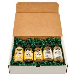 A gift box containing five bottles of different flavors of BBQ sauce.
