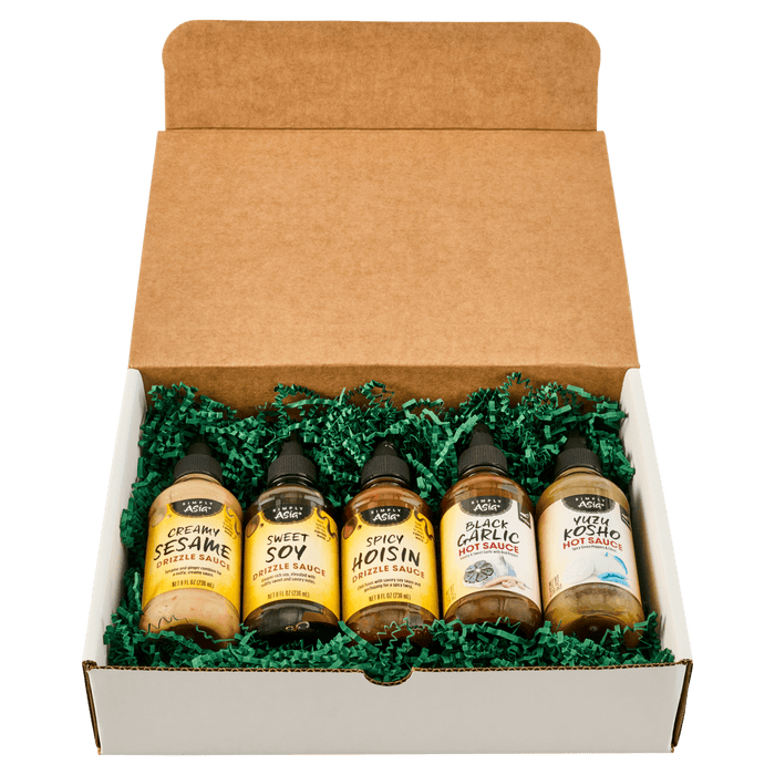 A gift box containing five bottles of different flavors of BBQ sauce.