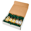 A gift box containing five bottles of various hot sauces nestled in green packaging material.