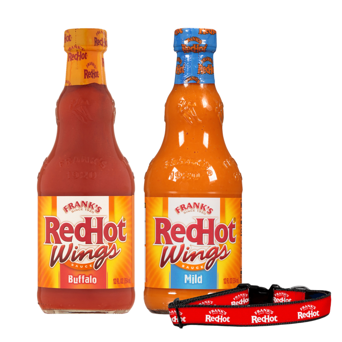 Two bottles of Frank's RedHot Wings sauce, one in a hot flavor and the other in a mild flavor, are displayed next to a Frank's RedHot dog collar.