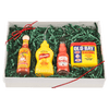 A gift box featuring Old Bay seasoning, Frank's RedHot sauce, French's mustard, and Texas Pete hot sauce, arranged on green decorative filler.