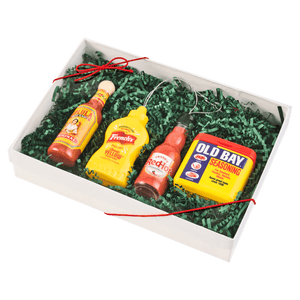 A gift box containing Cholula hot sauce, French's mustard, Heinz ketchup, and Old Bay seasoning.