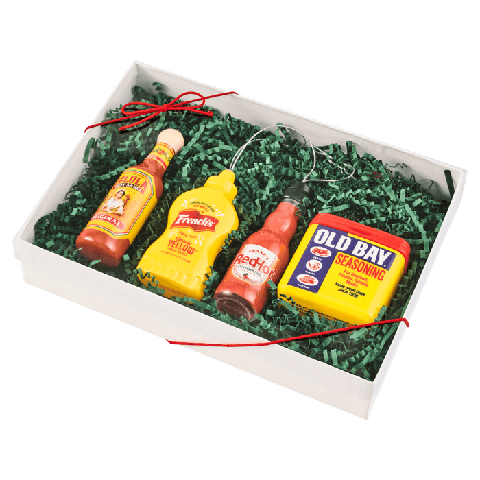 A gift box containing Cholula hot sauce, French's mustard, Heinz ketchup, and Old Bay seasoning.