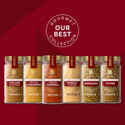 A collection of Gourmet Our Best spices in glass jars with gold lids, showcasing a variety of flavors.