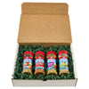 A gift box containing four bottles of Old Bay seasoning nestled in green paper filler.