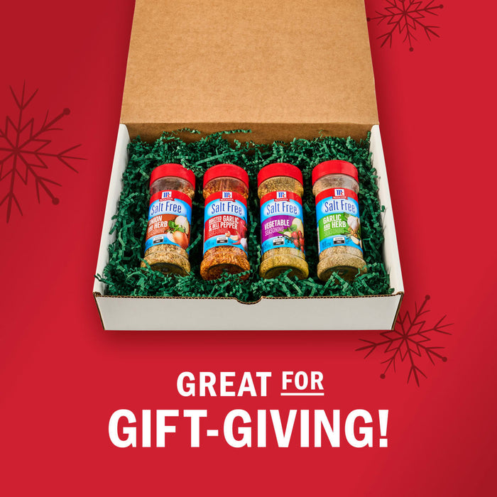 A gift box filled with four bottles of Kinder's seasonings, perfect for gift-giving.