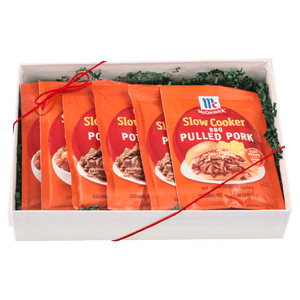 A gift box containing multiple packets of McCormick Slow Cooker Pulled Pork seasoning mix.