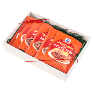 A gift box containing multiple packets of McCormick Slow Cooker Pulled Pork seasoning mix.