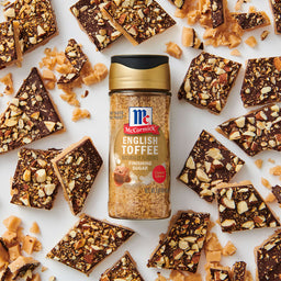 McCormick English Toffee Seasoning is displayed amidst scattered pieces of toffee bark, highlighting its use in enhancing dessert flavors.