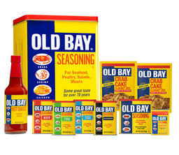 A collection of Old Bay seasoning products, including the classic seasoning, hot sauce, crab cake mix, and a wooden mallet.