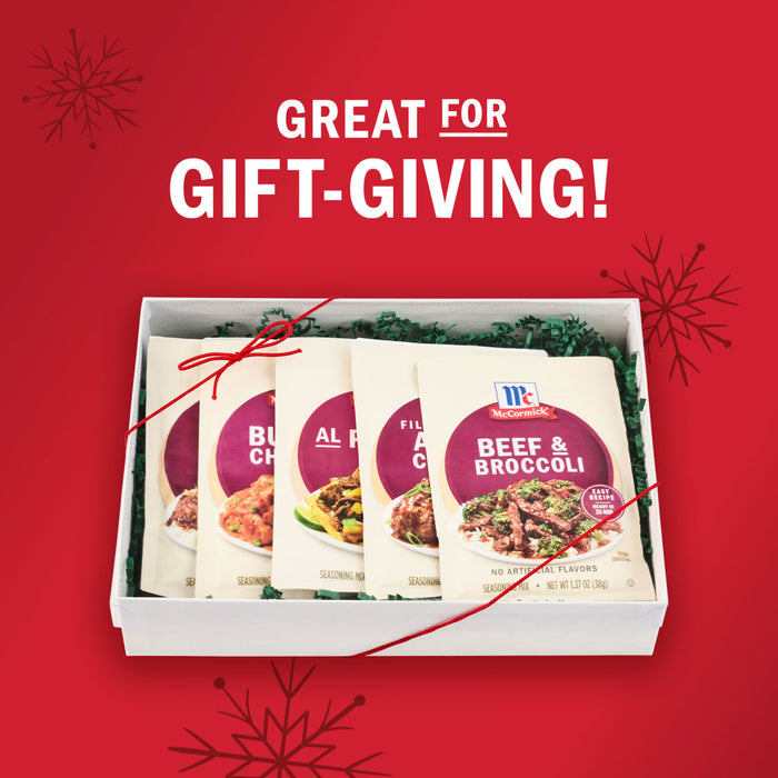 A McCormick gift set of seasoning packets is displayed in a white box with green filler, perfect for gift-giving.
