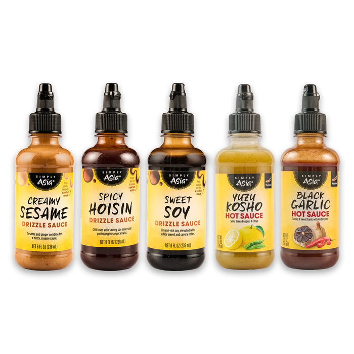 A collection of five bottles of Trader Joe's Umami Style drizzle sauces in various flavors.