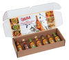 A Cholula Hot Sauce variety pack is displayed in an open box, showcasing seven different flavors like Original, Chili Lime, and Chipotle.