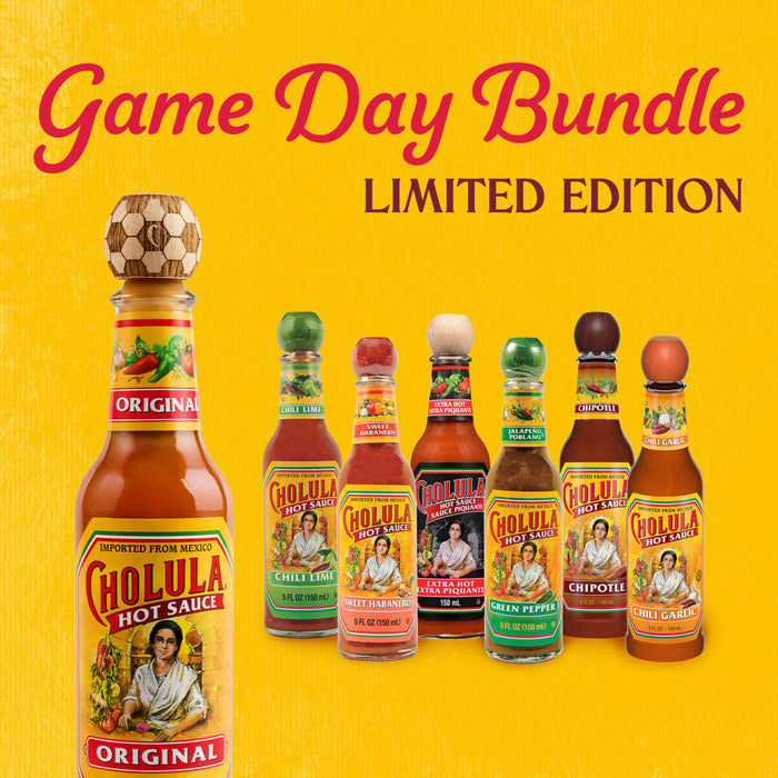 A promotional image for the limited edition Dtcchovpbundle shows a collection of Cholula Hot Sauce bottles, including Original with a special soccer ball cap, Chili Lime, Sweet Habanero, Extra Hot, Green Pepper, Chipotle, and Chili Garlic, all set against a vibrant yellow background.