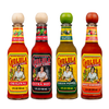 A lineup of four different bottles of Cholula Hot Sauce stands against a black background, showcasing the Original, Extra Hot, Green Pepper, and Sweet Habanero flavors.
