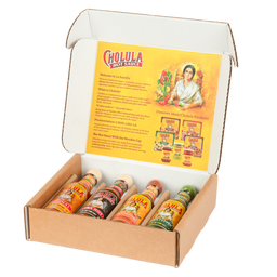 An open gift box displays a variety pack of Cholula Hot Sauce, featuring the Original, Extra Hot, Sweet Habanero, and Green Pepper flavors.