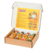 A Cholula hot sauce variety pack is displayed in an open cardboard box, showing four different flavors with their signature wooden caps.