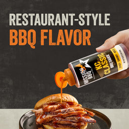 A hand pours a bottle of KC Classic BBQ sauce, part of the Mission Bbq Iw Dtc Pack Bundle Dtcmbbqvp, over a hearty meat sandwich to showcase its restaurant-style BBQ flavor.