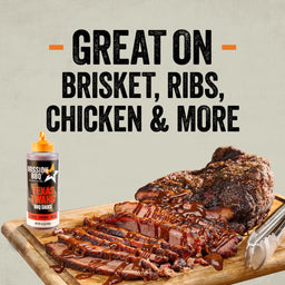 A bottle from the Mission Bbq Iw Dtc Pack Bundle Dtcmbbqvp sits next to a sliced brisket drizzled with the Texas Twang BBQ sauce to show it is great on brisket, ribs, chicken, and more.
