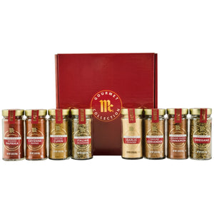 A product shot of the McCormick Gourmet Bundle Best Sellers Dtcmckvb features a red gift box behind eight jars of organic spices: Smoked Paprika, Cayenne Pepper, Ground Cumin, Italian Seasoning, Garlic Powder, Ground Coriander, Ground Saigon Cinnamon, and Oregano.