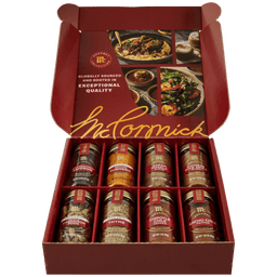 An open red gift box of the Gourmet Bundle Global Exploration Dtcmckvb from McCormick displays eight assorted spices from the Gourmet Collection, including Saffron, Turmeric, and Garam Masala.