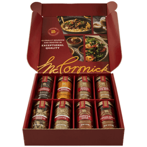An open red gift box of the Gourmet Bundle Global Exploration Dtcmckvb from McCormick displays eight assorted spices from the Gourmet Collection, including Saffron, Turmeric, and Garam Masala.
