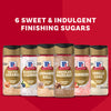The McCormick Finishing Sugar Bundle is displayed against a red background, featuring six bottles of flavored sugars: Salted Caramel, Blueberry &amp; Lemon, Cinnamon Roll, Chocolate Hazelnut, Strawberry, and Vanilla Cake.