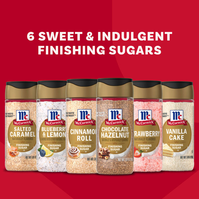 The McCormick Finishing Sugar Bundle is displayed against a red background, featuring six bottles of flavored sugars: Salted Caramel, Blueberry &amp; Lemon, Cinnamon Roll, Chocolate Hazelnut, Strawberry, and Vanilla Cake.
