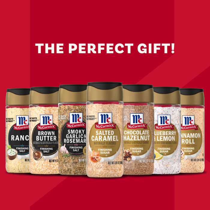 An advertisement from McCormick presents a lineup of various finishing salts and sugars, including Ranch, Brown Butter, and Salted Caramel, with the text THE PERFECT GIFT! displayed above them on a red background.
