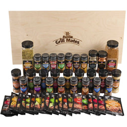 A comprehensive collection of McCormick Grill Mates seasonings and marinades is displayed in front of a large wooden crate featuring the brand logo.