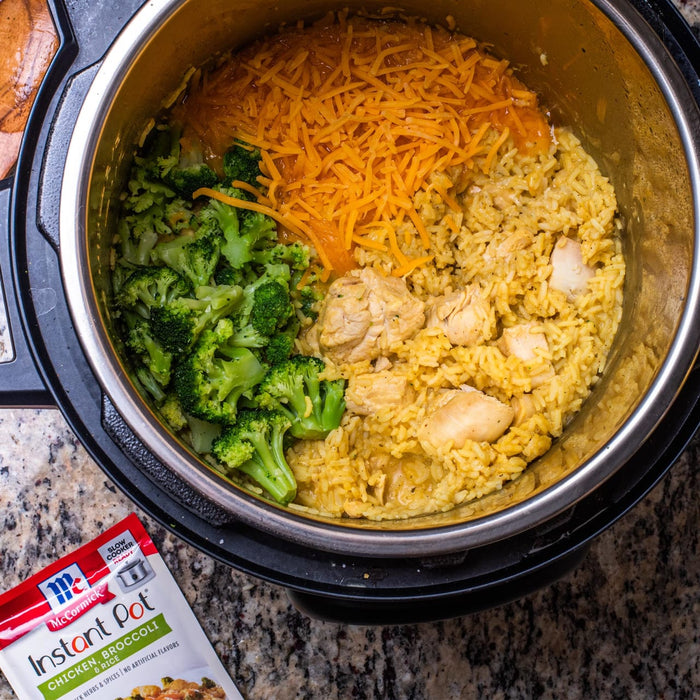 A close-up of a McCormick Instant Pot Chicken Broccoli &amp; Rice recipe in a pressure cooker.