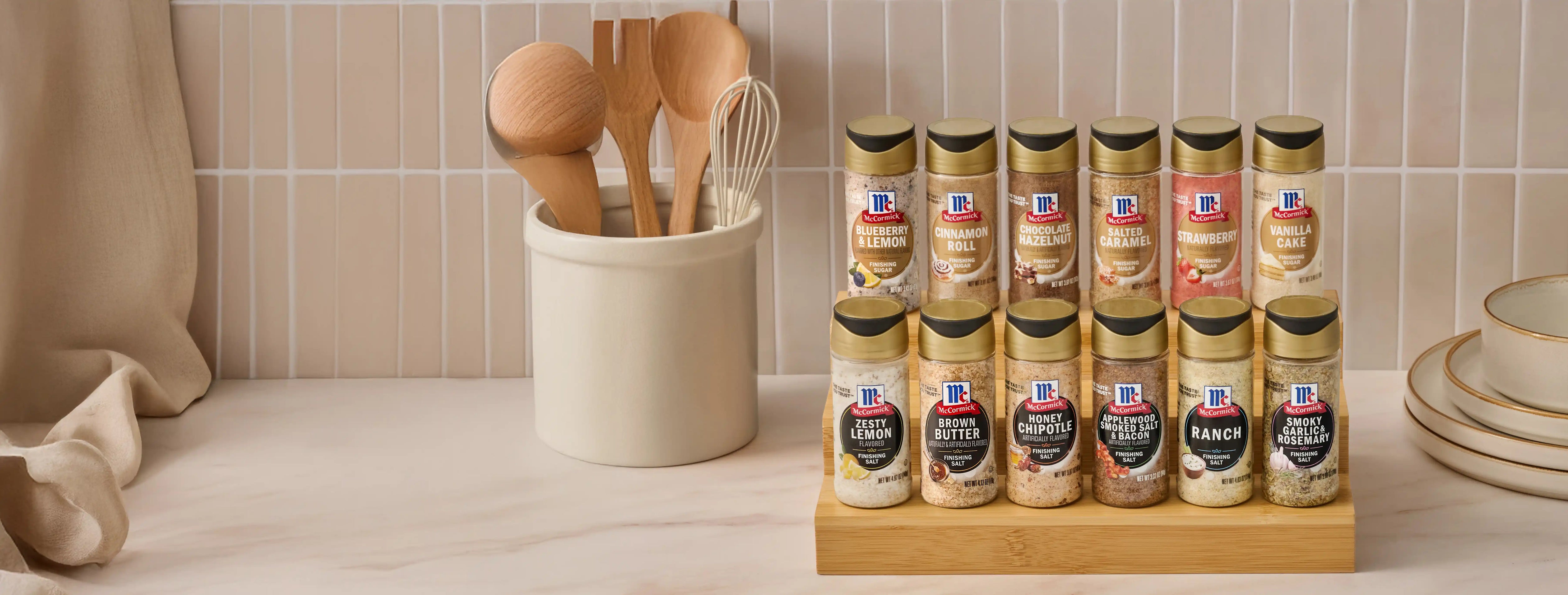 McCormick finishing sugars and salts family shot on a kitchen counter with a ceramic utensil crock
