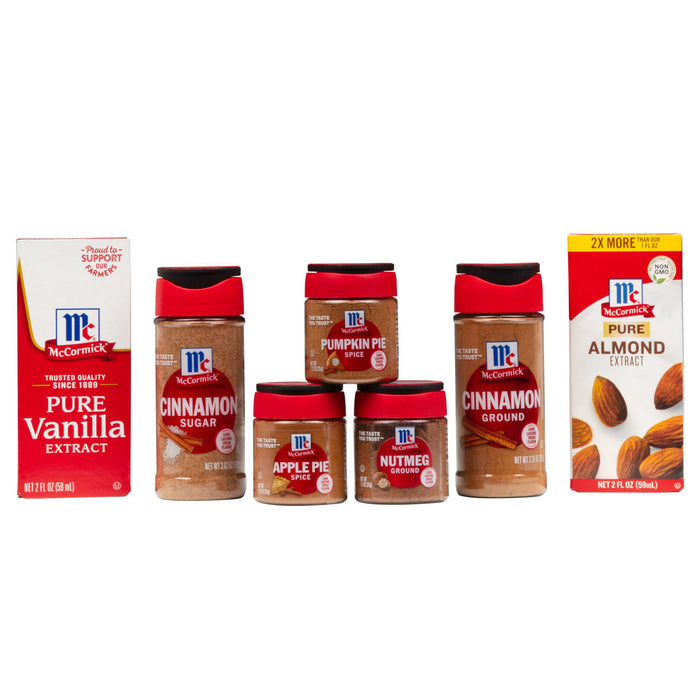 A collection of McCormick spices and extracts including vanilla cinnamon nutmeg apple pie spice and almond extract.