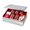 A silver tin filled with McCormick spices and almond extract.
