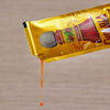 A packet of Cholula Original Hot Sauce with a drop of sauce dripping from the bottom.