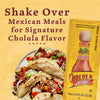 A plate of tacos topped with Cholula hot sauce with a packet of Cholula hot sauce in the background.